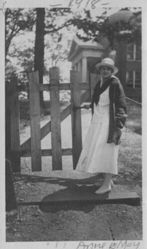 Anne May beside gate in Front of Founder's Hall