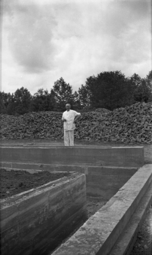 3.7.14: Frank Campbell, college baker, observes the laying of the foundation of Walker Hall in 1934.