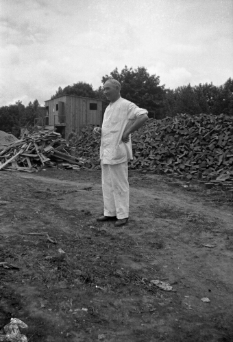 3.7.13: Frank Campbell, college baker, observes the laying of the foundation of Walker Hall in 1934.
