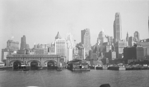 7.1.6:  "New York Skyline showing the ferry slips (wharves). Note barges and ferry  boat." - from the back of the photo