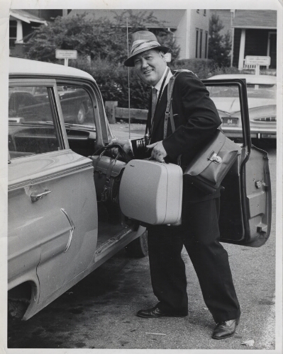 Bill Blizzard heading to work at the Charleston Gazette with his camera and gear around 1952-53.