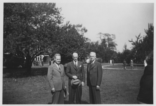 2.17.4: Dr. Peters with others on campus, c. 1940s