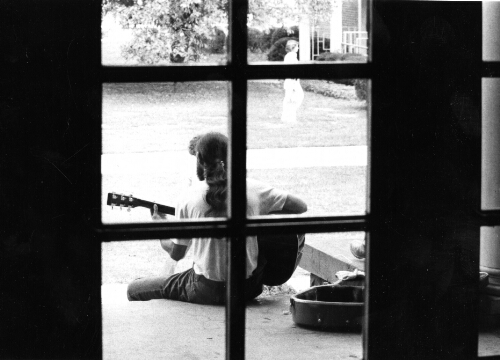 6.8.11: Student playing guitar on campus, 1979