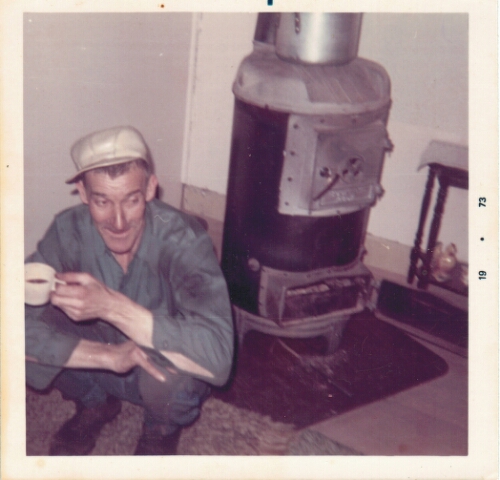 Harley Cordle beside his wood stove, 1973.